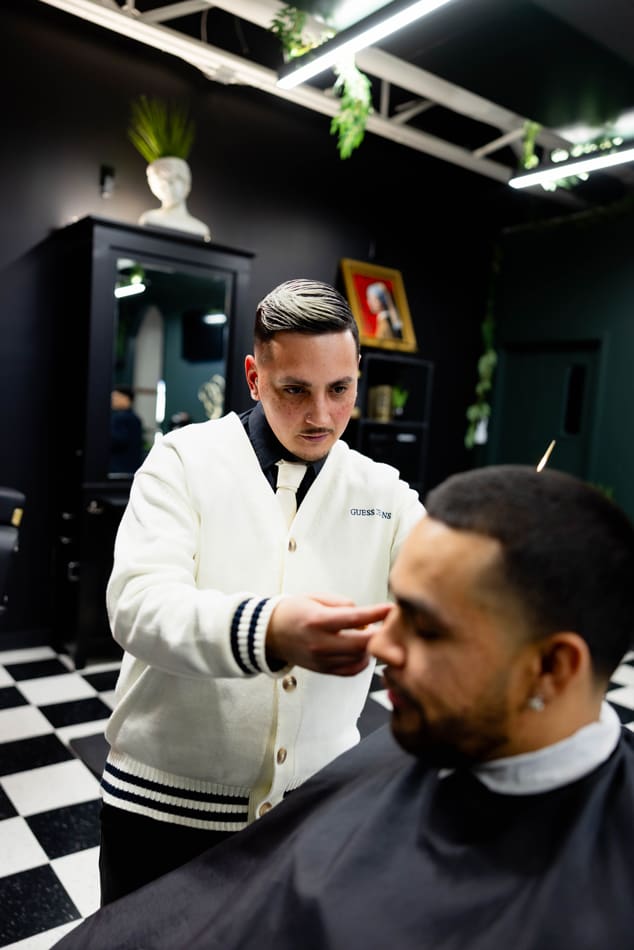 Man cutting another man's hair